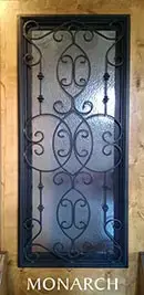 A wrought iron door with the word monarch on it.