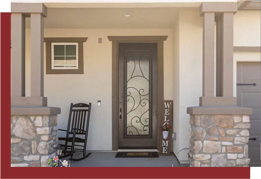 The front door of a home with a rocking chair.