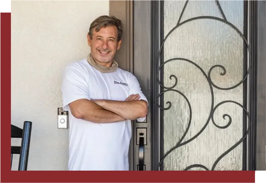 A man standing in front of an iron door.